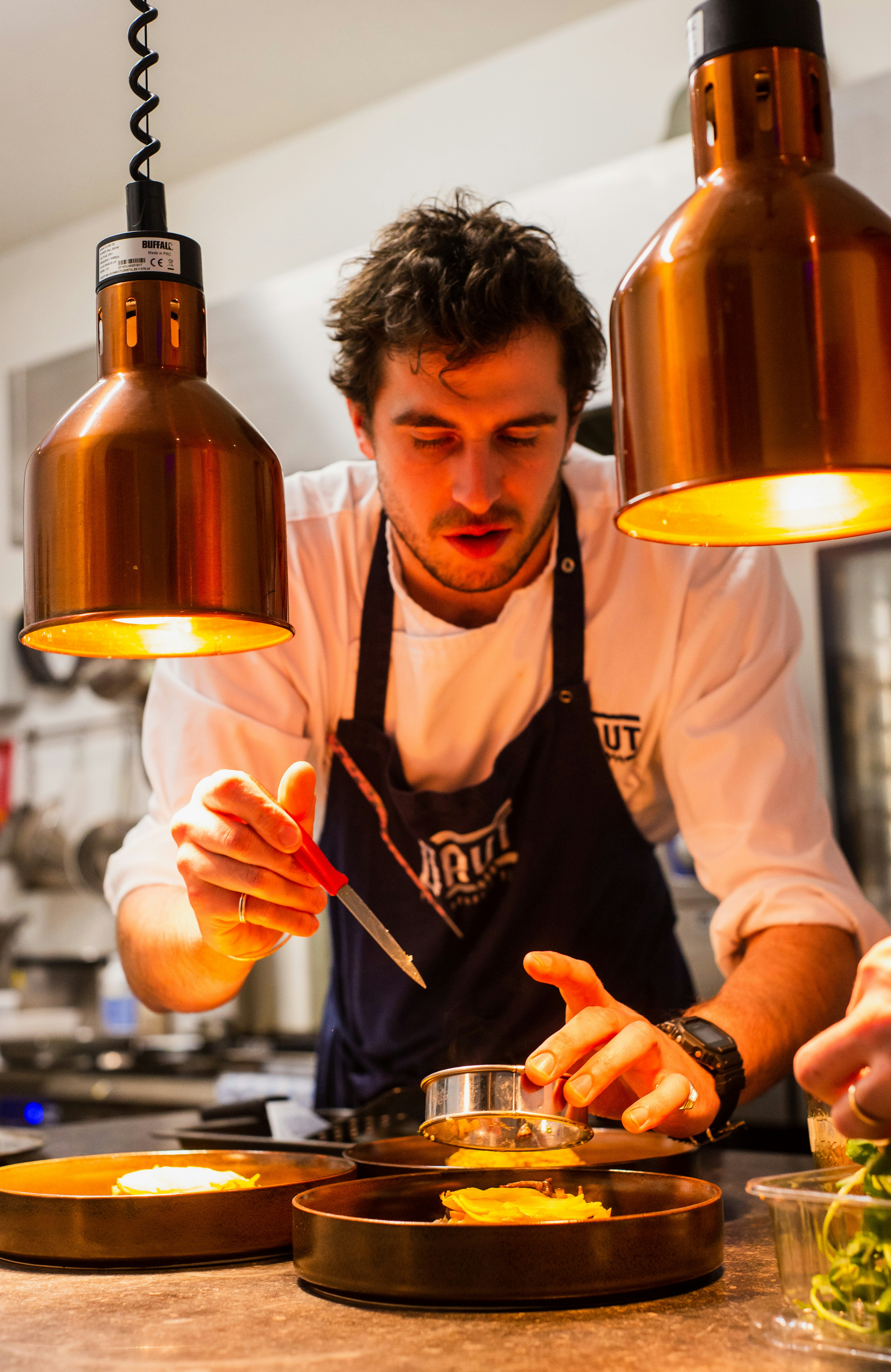 A home chef plating a dish with pride